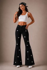 Black high-waisted bell bottom jeans with silver diamond star embellishments – front view