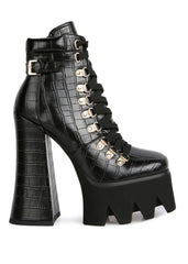 Side view of black biker boots showing platform heel and side zipper closure