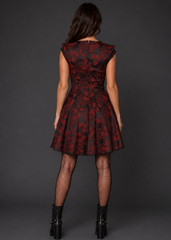 Back view of black and red gothic brocade corset dress showing floral print detail and flared skirt silhouette
