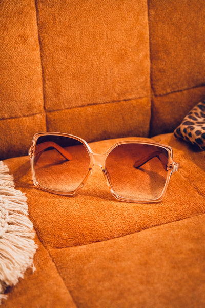 Sunglasses on a textured brown surface