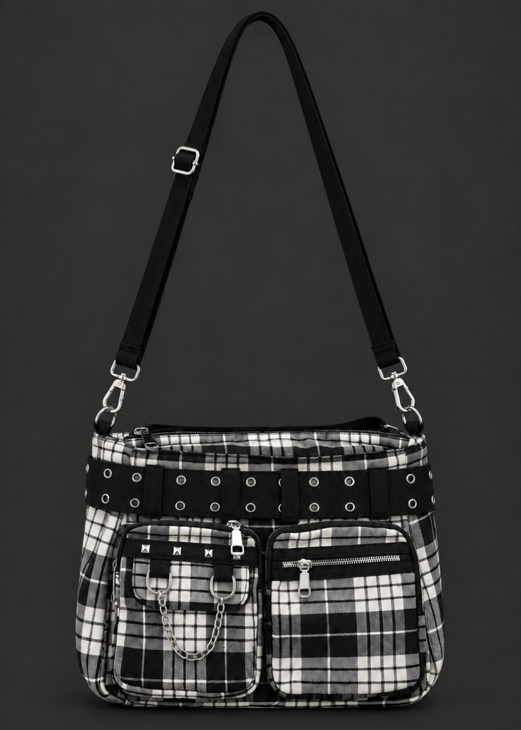 Front view of a black and white plaid punk handbag with an eyelet belt, studded front pocket, silver chain and adjustable shoulder strap