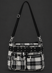 Front view of a black and white plaid punk handbag with an eyelet belt, studded front pocket, silver chain and adjustable shoulder strap