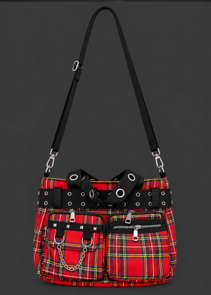 Front view of a red tartan plaid handbag with black grommet straps, zippered pockets, silver studs and chain detail.
