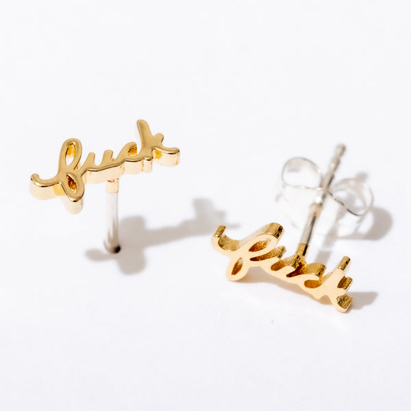 Gold 'luck' earrings on a white background