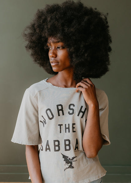 Woman wearing a t-shirt with 'Worsh The Jabba' text and graphic design Ozzy Osbourne 