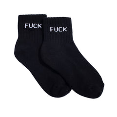 Black socks with 'FUCK' printed on them against a white background