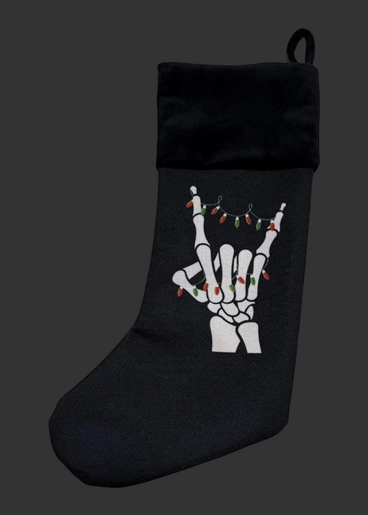 Black Christmas stocking with skeleton hand design on a white background