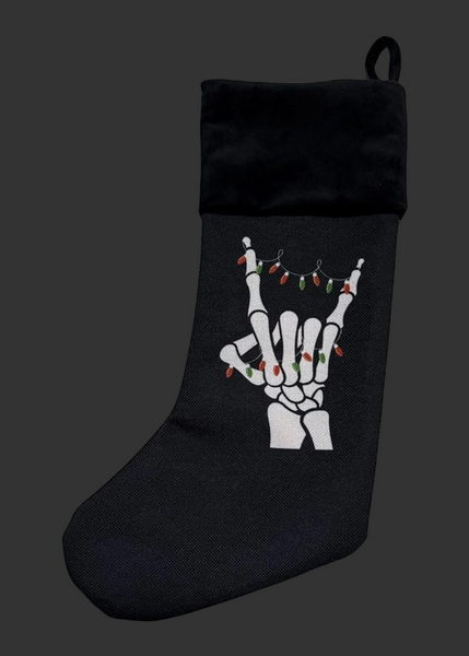 Black Christmas stocking with skeleton hand design on a white background
