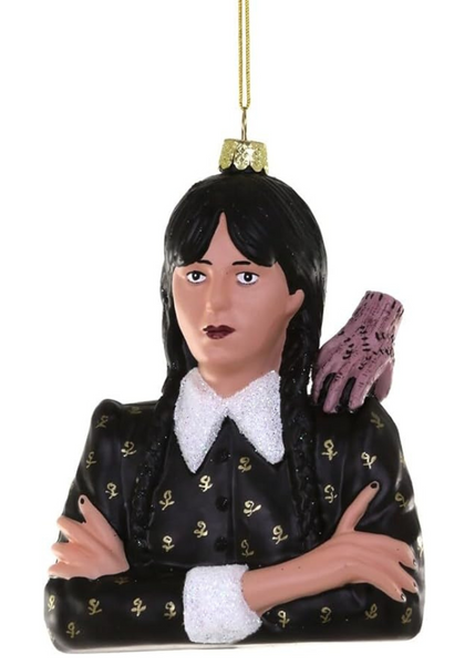 Decorative Wednesday ornament of a character with long black hair and a black outfit with gold accents on a white background.