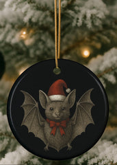 Decorative ornament with a bat wearing a Santa hat on a Christmas tree.