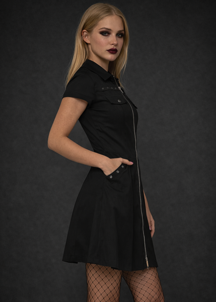 Alternative black gothic mini dress with front zipper and stud details, dark academia goth outfit styled with fishnet tights.