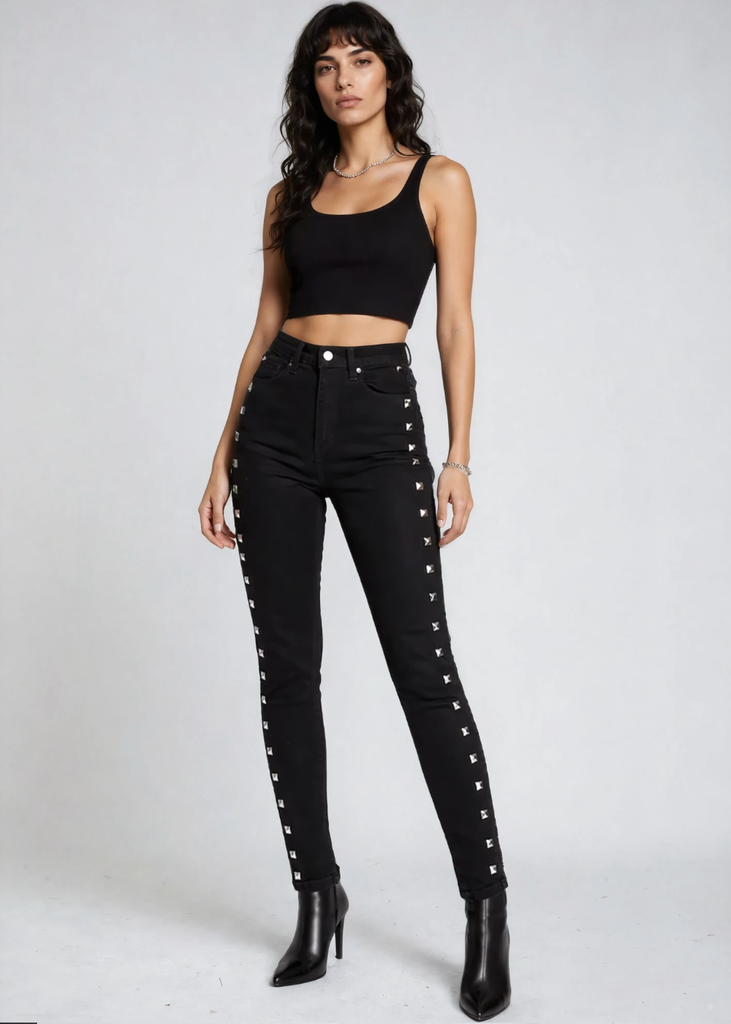 Black studded skinny jeans for women, edgy punk rock denim pants with metal studs and alternative fashion style.