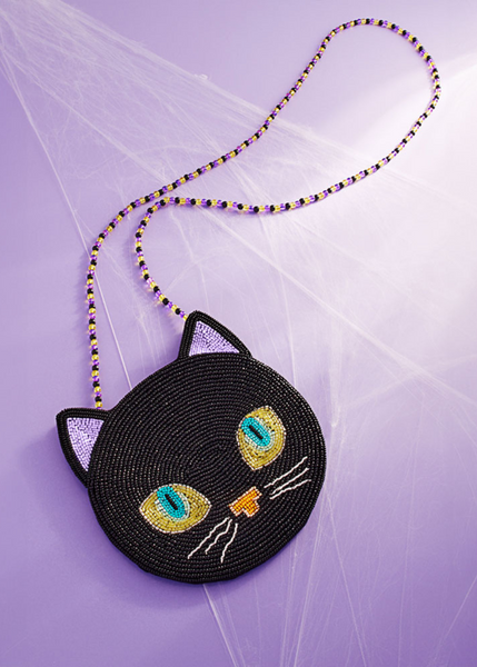 Black cat-shaped purse with colorful eyes on a purple goth Halloween witch 