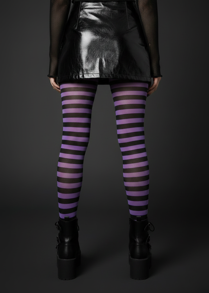 Black and purple striped opaque Halloween tights styled with a black patent mini skirt and platform boots – back view
