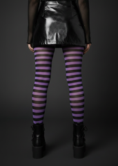 Black and purple striped opaque Halloween tights styled with a black patent mini skirt and platform boots – back view