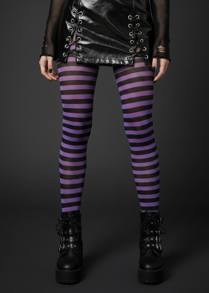Black and purple striped opaque Halloween tights styled with a black patent mini skirt and platform boots – front view