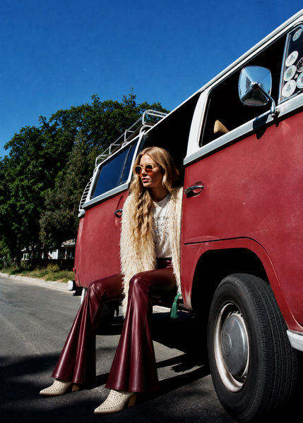 Women's burgundy faux leather flare pants with ruffle hem - back view

