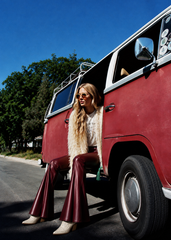 Women's burgundy faux leather flare pants with ruffle hem - back view
