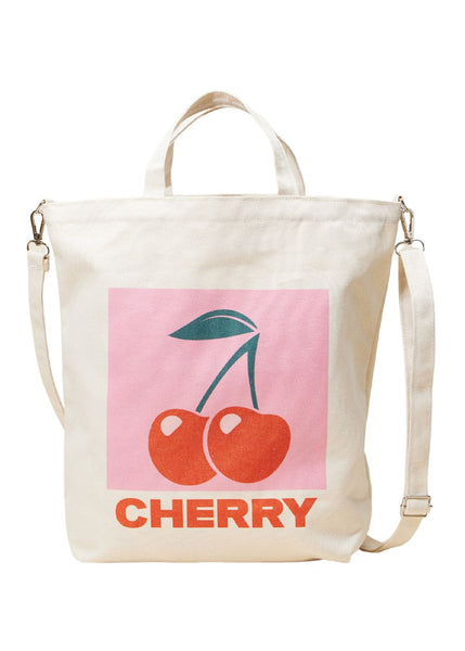 Cherry print canvas tote bag with top handles and crossbody strap on white background