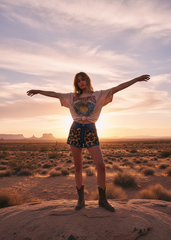 Free-spirited woman in leopard denim shorts at golden hour – bohemian festival style made in USA
