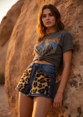 Woman wearing leopard faux fur denim shorts in desert setting – rock-n-roll boho concert outfit