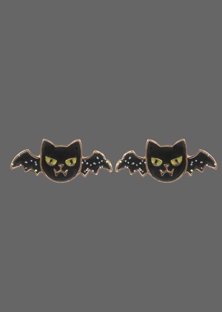 A pair of black bat-shaped enamel pins with yellow eyes and small white star details on the wings, shown against a plain white background.
