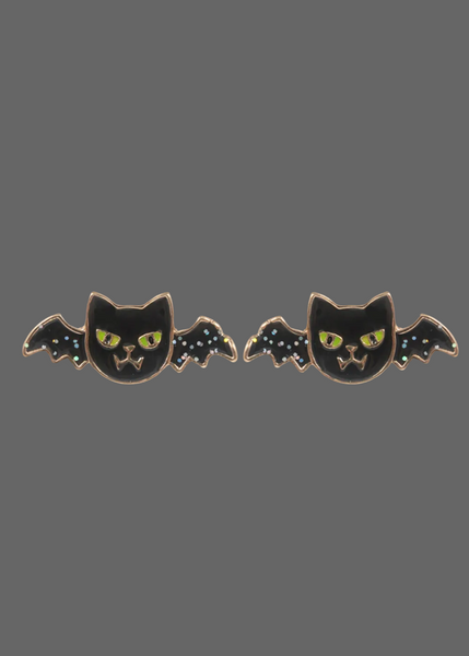 A pair of black bat-shaped enamel pins with yellow eyes and small white star details on the wings, shown against a plain white background.