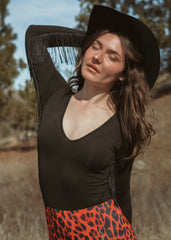 V-neck black bodysuit with fringe – Chic long-sleeve bodysuit featuring flowing fringe for a bold, edgy look