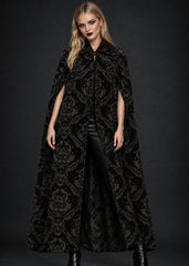 Gothic black cape layered as dramatic alternative outerwear