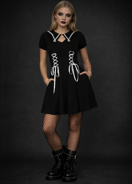 Alternative gothic black skater dress with corset lace side details and collar neckline, styled with fishnet tights and combat boots for a dark academia goth outfit.