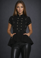 Black gothic military style top with metal button details and peplum waist worn with black leather pants on dark gray studio background