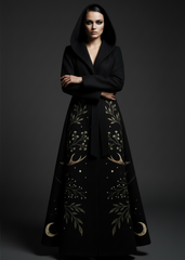 Front view of women's black witchy hooded belted coat with botanical leaf and crescent moon print, floor-length gothic outerwear
