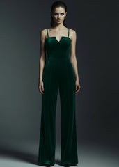 Women's green velvet wide leg jumpsuit party outfit with V-neckline and spaghetti straps