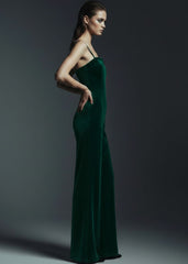 Side view of emerald green velvet wide leg jumpsuit showing flowing silhouette and open back