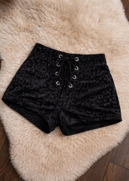 Women's black velvet lace-up shorts side view – stretchy corset-style hot pants