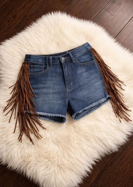 Festival-ready fringe denim shorts for women – bohemian cowgirl style with suede tassels and raw cutoff hem
