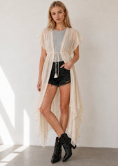 Sheer flowy beach cover-up maxi kimono with tie front closure styled over a bikini at the beach
