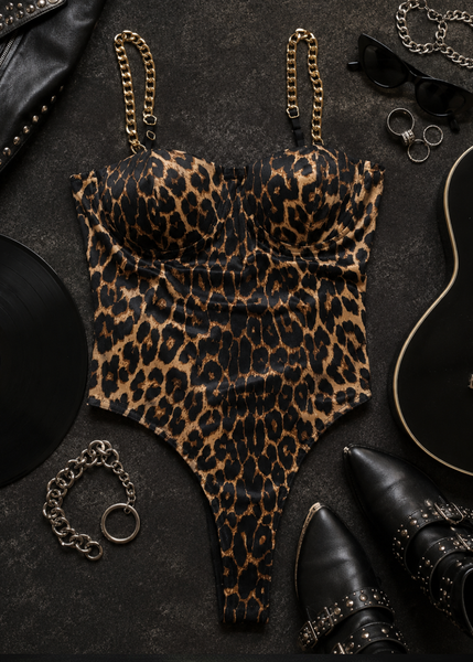 Leopard print bustier bodysuit with gold chain straps - side profile view on model with black ankle boots