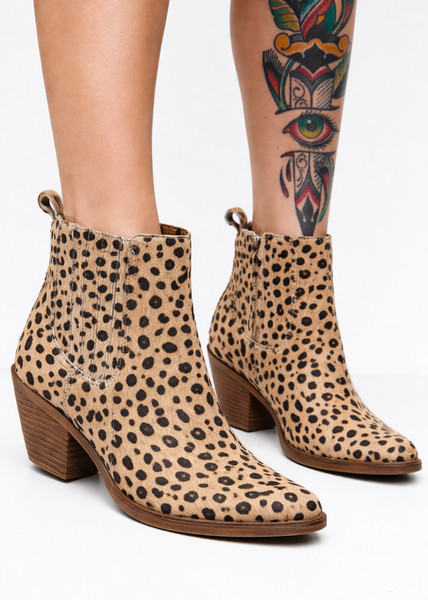 Leopard print ankle boots worn with tattooed legs for concert outfit ideas