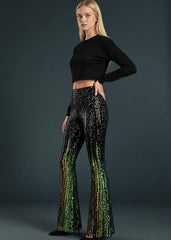 Close up of ombre black and green sequin fabric on flare pants