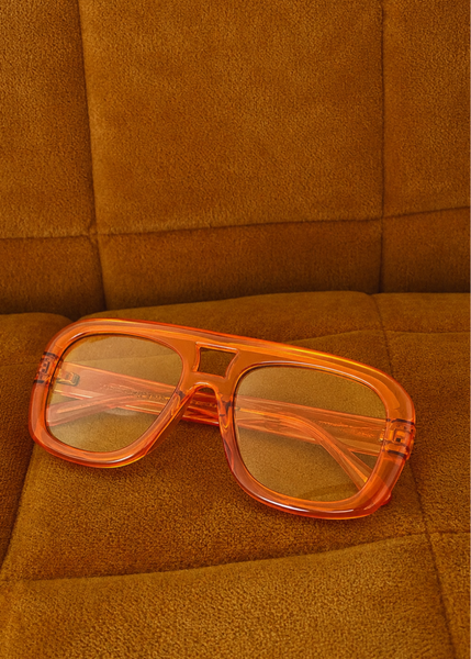 70s-inspired square aviator sunglasses in orange with gold frames and warm tan lenses, women's festival style