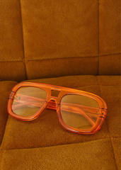 70s-inspired square aviator sunglasses in orange with gold frames and warm tan lenses, women's festival style