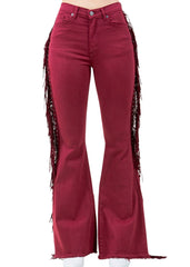 Red denim bell bottoms with,zipper closure, and fringe tassels. Perfect for festival pants and concert outfits.