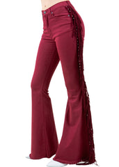 Model wearing burgundy red fringe bell bottom jeans with flared legs and tassel detail