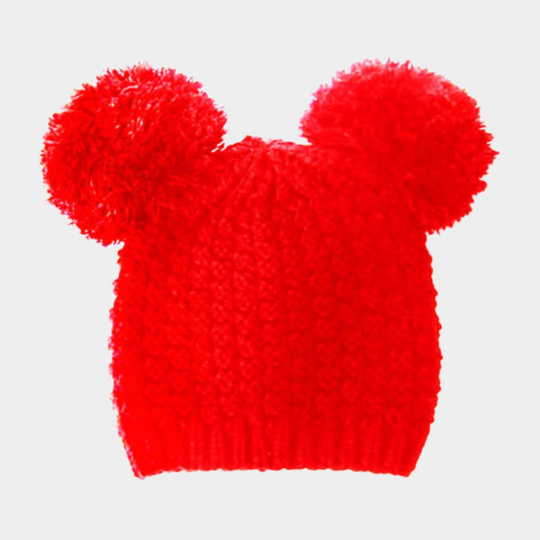 Red knitted hat with two large pom-poms on a light gray background