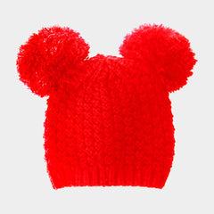 Red knitted hat with two large pom-poms on a light gray background