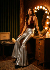 Silver ruffle bell bottoms styled for festival — metallic faux leather flare pants full length view
