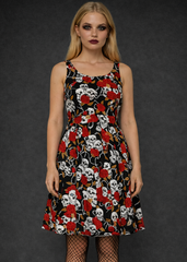 Black gothic skull and red rose dress with A-line silhouette styled with fishnet tights and combat boots, alternative punk goth fashion outfit.