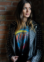 Black studded moto jacket styled with leopard print pants - festival outfit inspiration