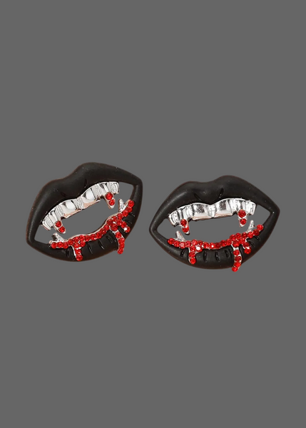 Vampire fang stud earrings in silver gothic bite design on white background

